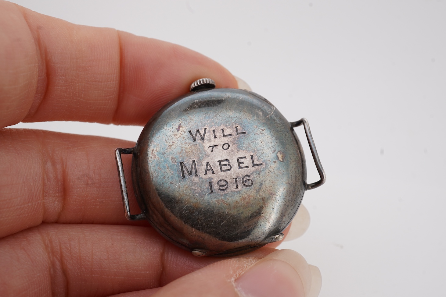 A lady's early 20th century silver nurse's or medic's manual wind wrist watch, with Red Cross symbol on the dial, engraved inscription on the back, 'Will to Mabel, 1916', case import marked for London, 1914, no strap.